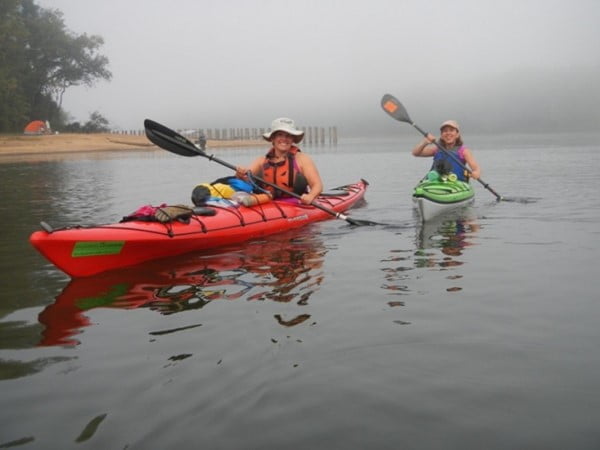 2 women paddling on a foggy day
