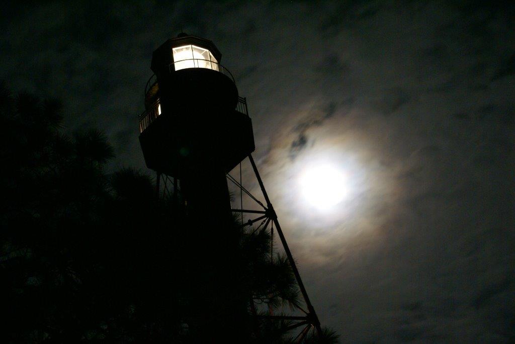 Full Moon shining behind Crooked River Lighthouse at night
