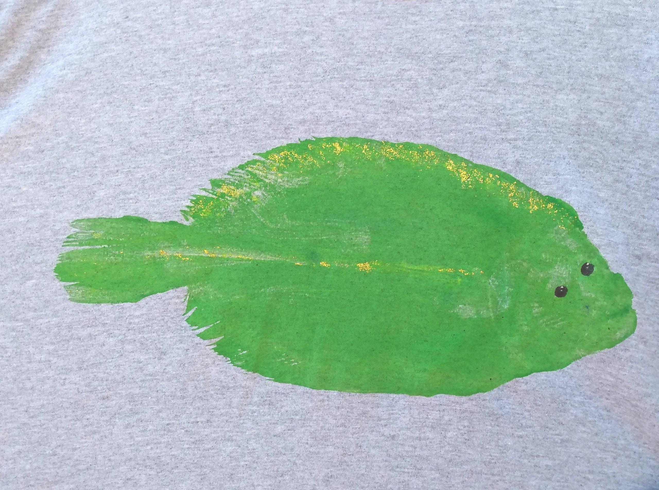 Bright green painted fish imprint on a gray t-shirt
