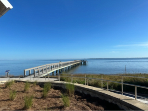 Pier and boardwalk with blue water and blue sky