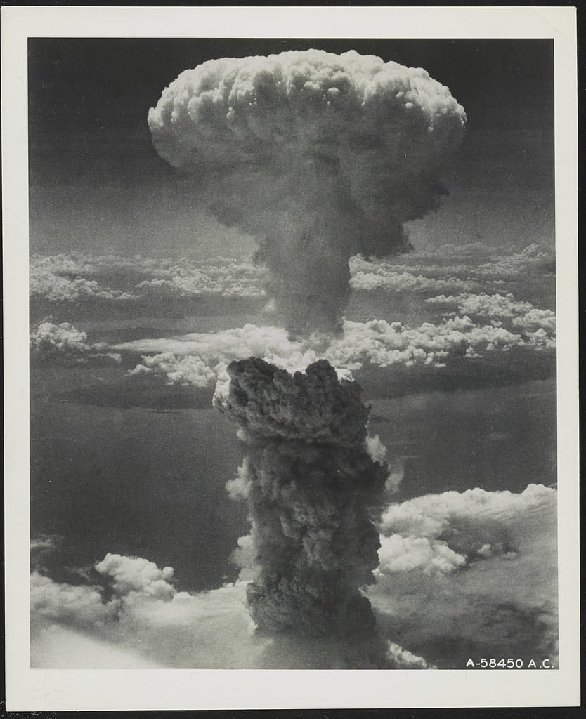 A large explosive cloud rises from the ground into the sky